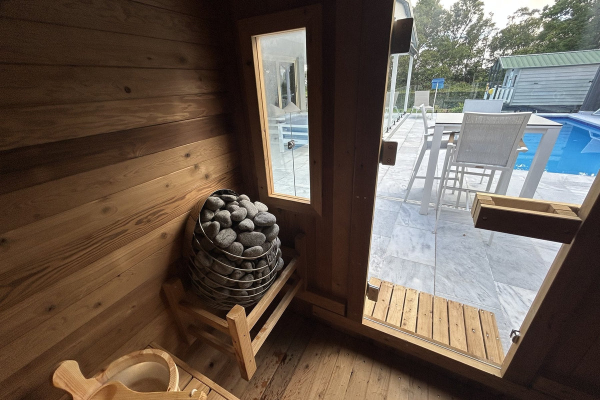 Heater stones, bucket and ladle inside a traditional Nova Sauna