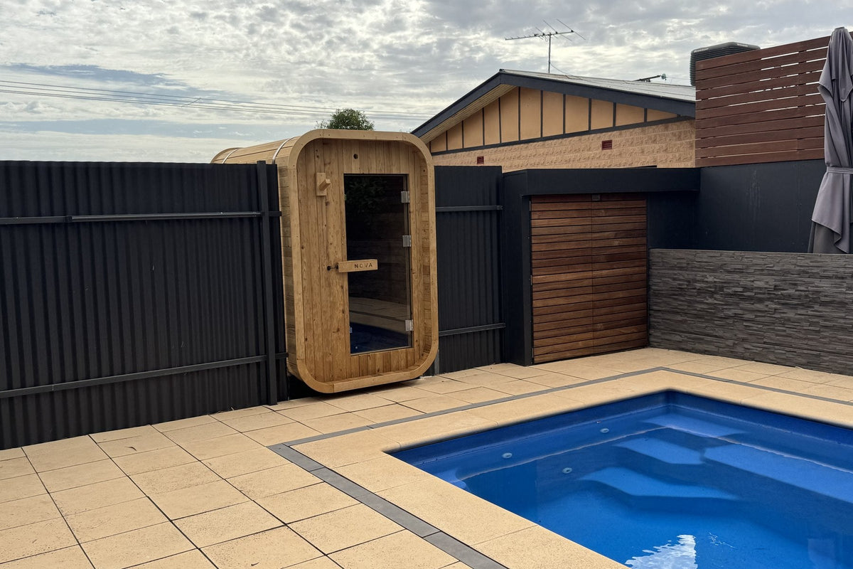 Nova Sauna Lite outdoor sauna beside a backyard pool