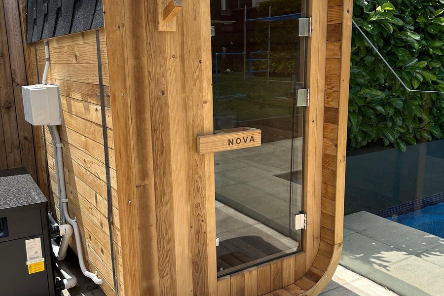 Nova Sauna Lite installed on a level paved base beside a pool