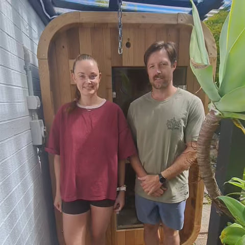 Nova sauna owners beside their outdoor saunas